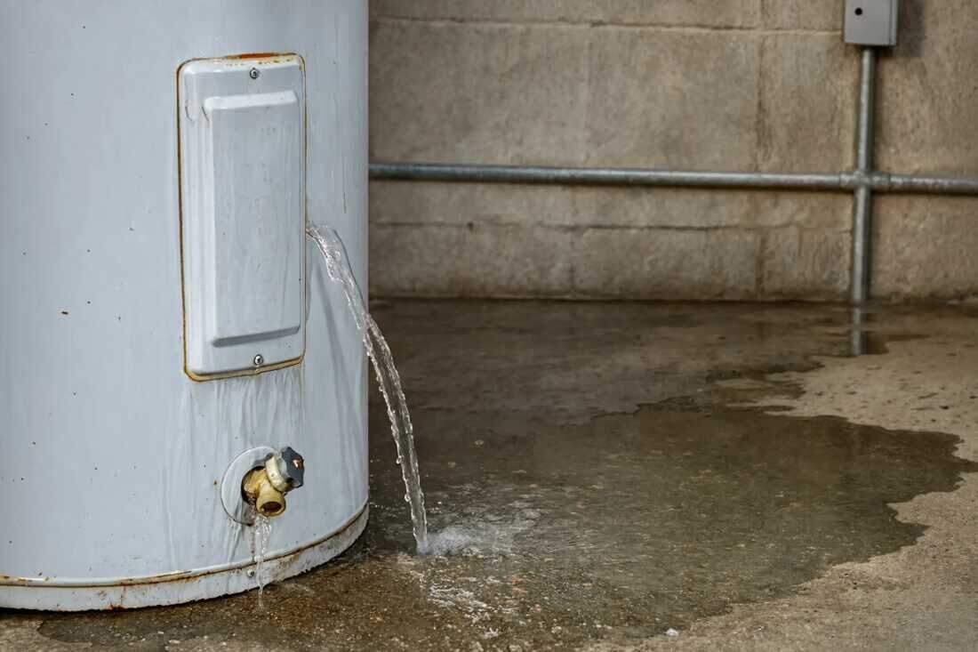 A Brooklyn technician inspecting water damage from a leaking appliance