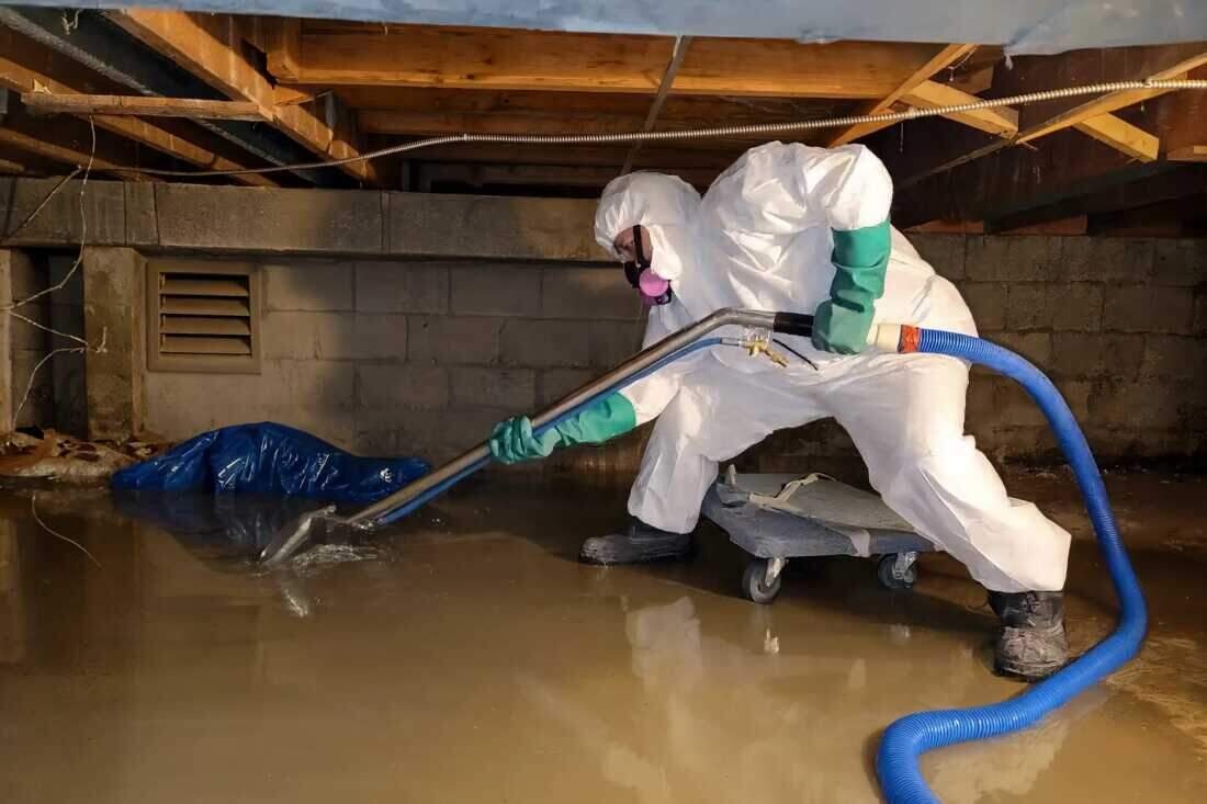 A flooded Brooklyn basement being pumped out and cleaned